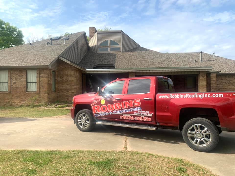 Robbins Roofing company truck in front of home.