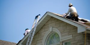 Construction workers repairing a roof.