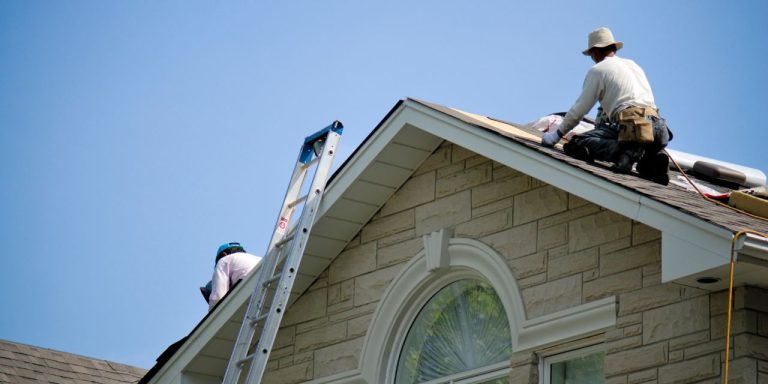 Construction workers repairing a roof.