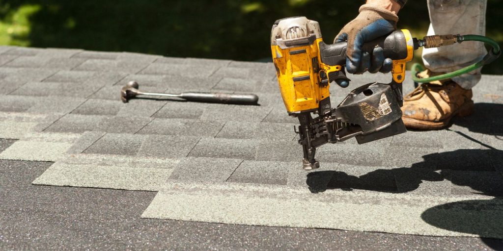 Asphalt shingles being placed on a roof.