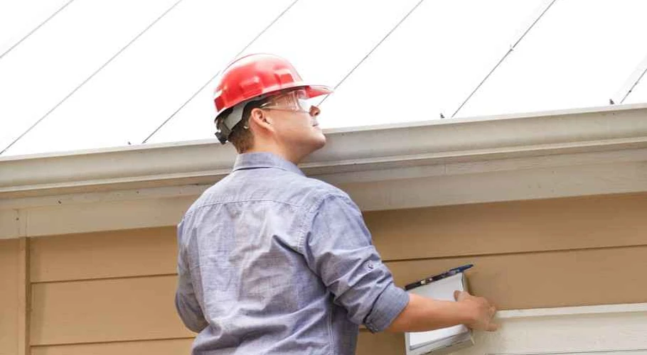 Checking for visible signs of damage on roof