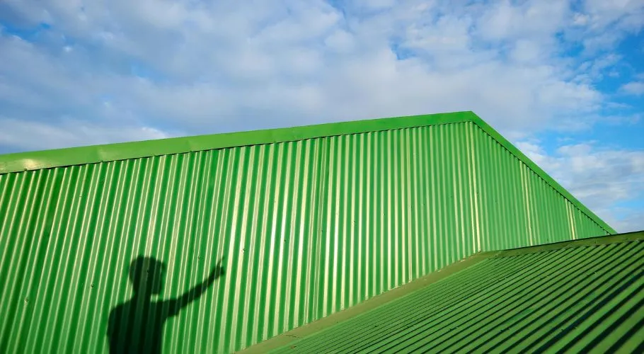 green metal roofing and cloudy sky
