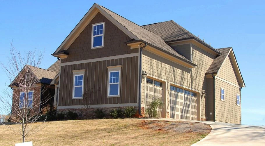 A large house with a beige and brown color palette, plus wood elements.