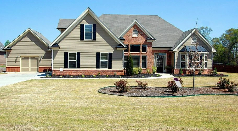House painted with neutral colors and brick elements.