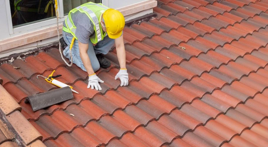 Roofer replacing shingles