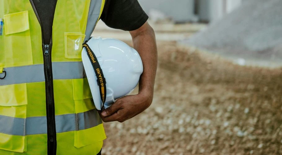 Man holding a hard hat.