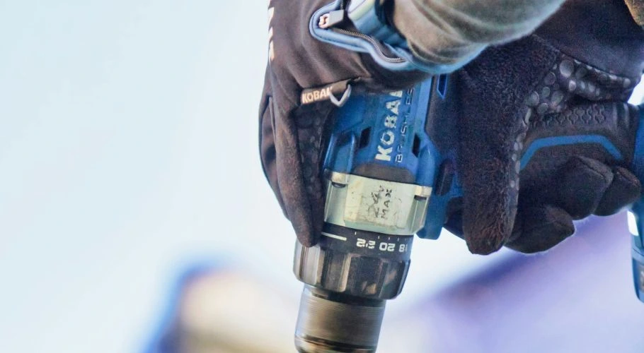 Person using a roofing nail gun.