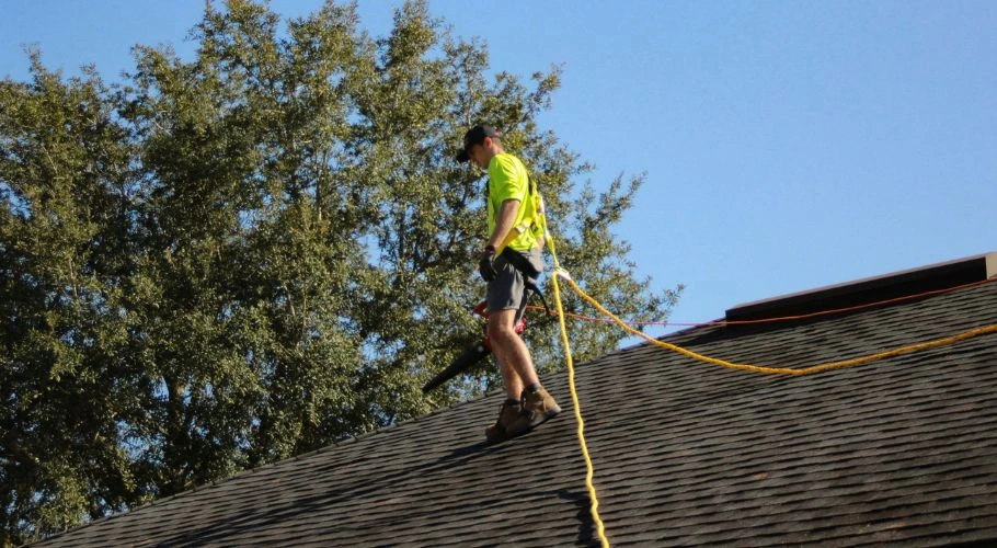 Roofer inspecting a roof.
