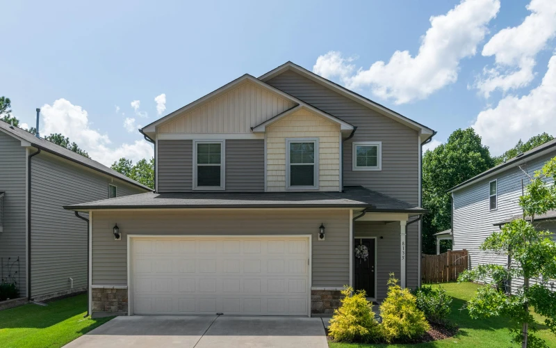 A two-story house with a front lawn