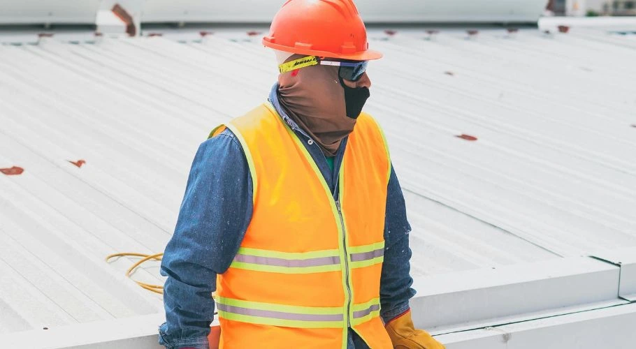 professionl roofer inspecting a metal roof