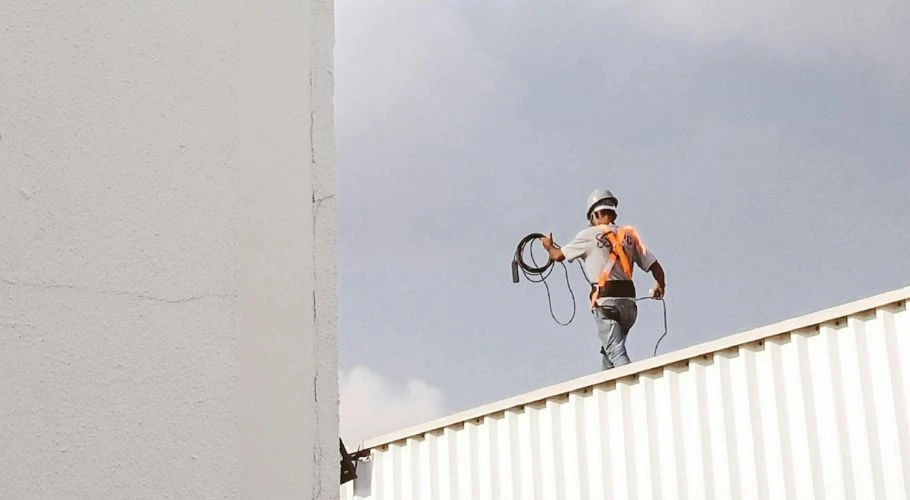 roofer inspecting a commercial roof