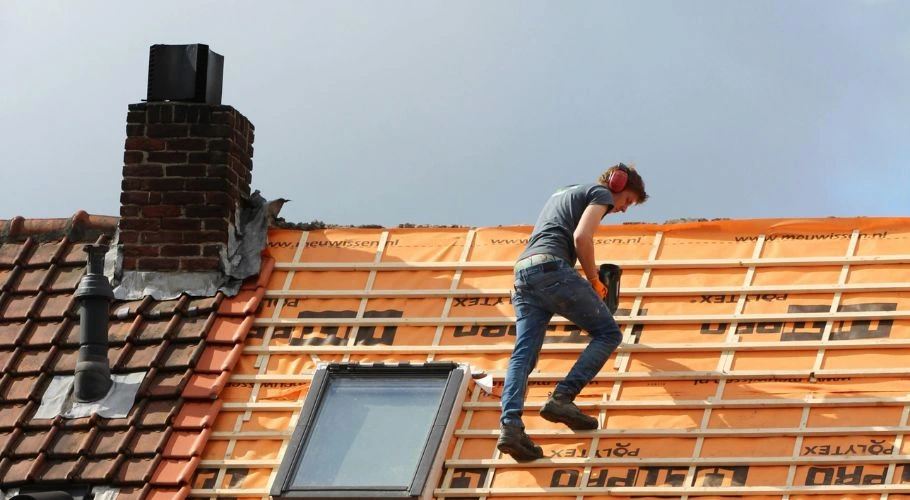 roofer working on a roof replacement project