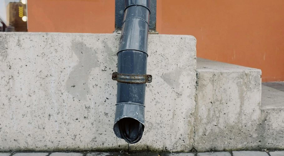 downspout dripping with water
