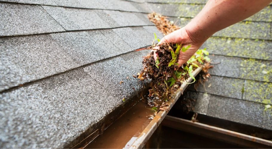 man cleaning gutter
