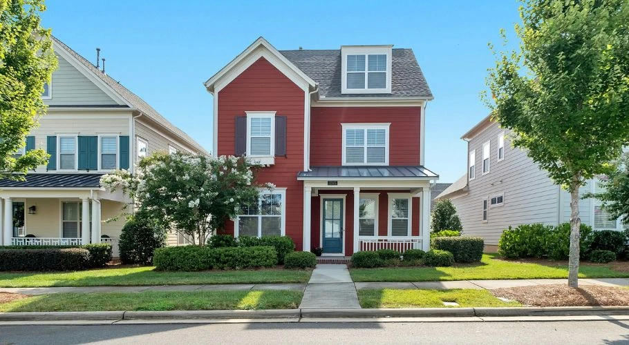beautiful house with red siding and gray roof