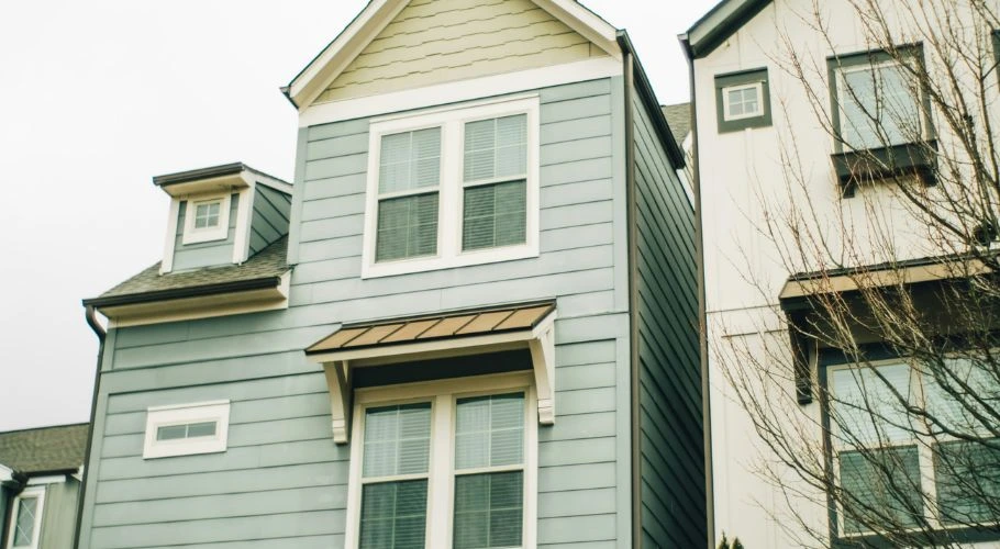house with green insulated vinyl siding