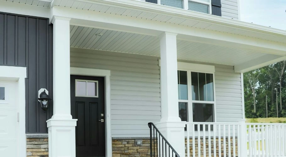 house with white siding and a black door